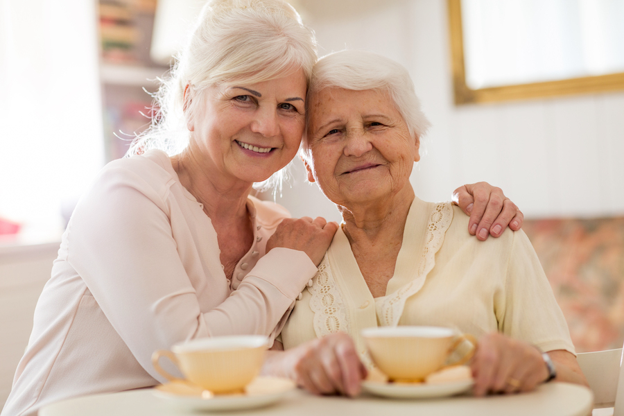 Senior woman spending quality time with her adult daughter discussing senior living options